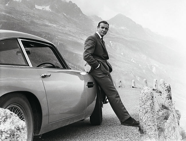 James Bond (Sean Connery) and his iconic Aston Martin DB5, filming Goldfinger (1964) at the Furka Pass, Switzerland.  James Bond films © 1962-2012 Danjaq, LLC and United Artists Corporation. All rights reserved